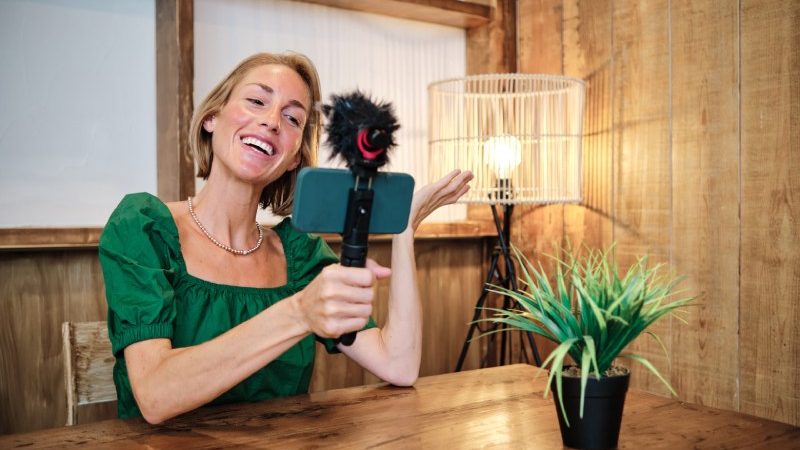 Adult woman influencer with smartphone